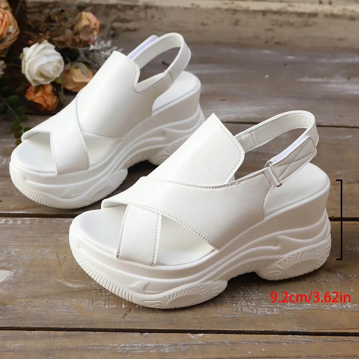 White sandals with thick soles on a wooden surface