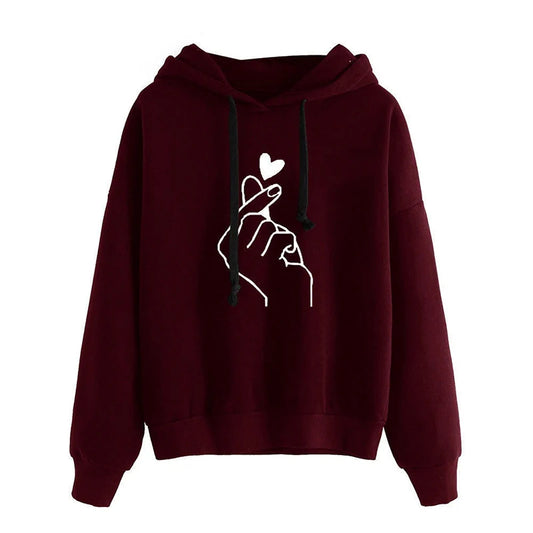 Maroon hoodie with a white hand holding a heart design on a white background