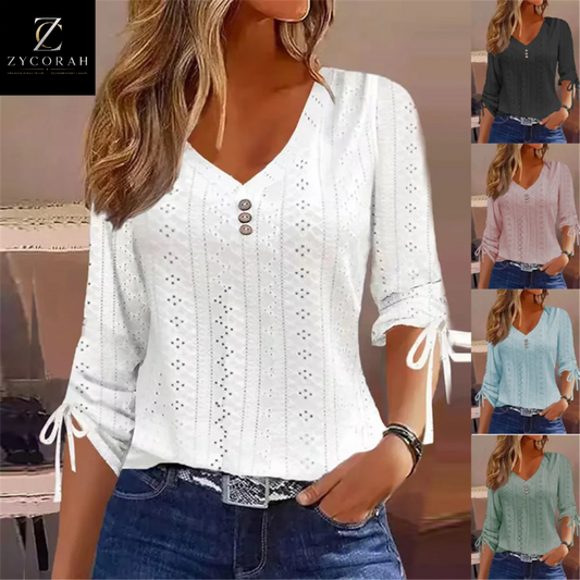 A woman wearing a white eyelet knit V-neck blouse with three-quarter sleeves, tie details at the cuffs, and a button placket. The main image is on the left, with four smaller color variant thumbnails on the right showing the blouse in gray, pink, blue, and mint green.