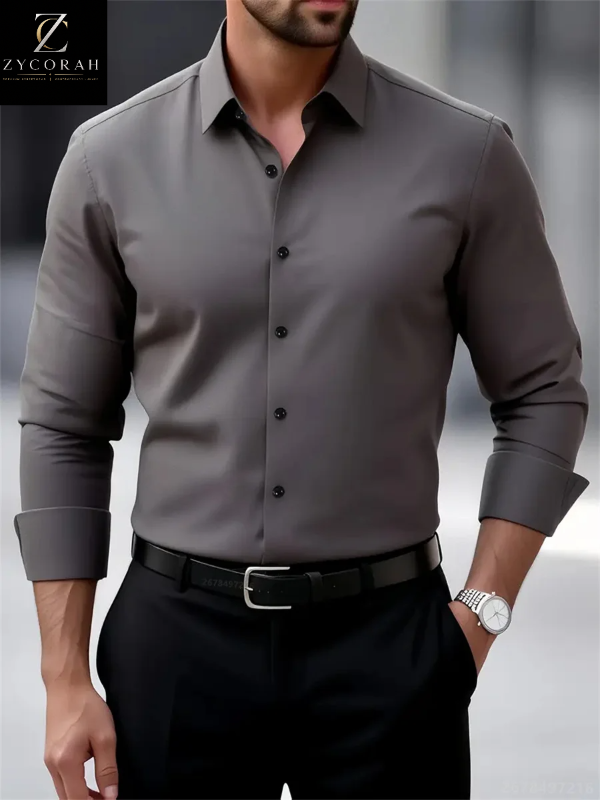 A man wearing a long-sleeve gray dress shirt with black trousers and a black belt, shown from the waist up. The ZYCORAH brand logo is visible in the top-left corner.