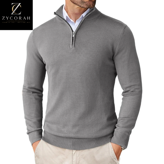 A man wearing a gray quarter-zip knit sweater over a white collared shirt and light beige pants. The ZYCORAH brand logo is visible in the top-left corner.