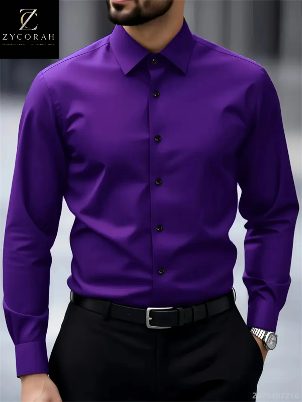 A man wearing a vibrant purple long-sleeve button-down dress shirt with black buttons, paired with a black belt and trousers. The Zycorah brand logo is visible in the top-left corner.