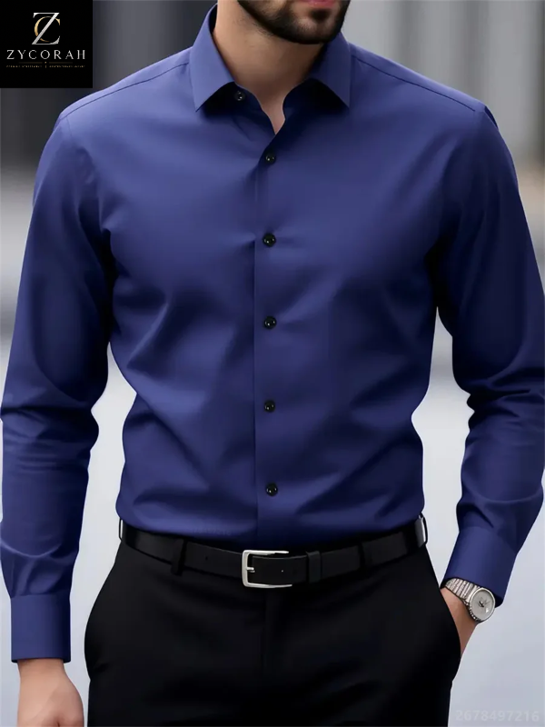 A man wearing a long-sleeve button-down dress shirt in a rich royal blue color, paired with black trousers and a black belt. The brand logo 'ZYCORALL' is visible in the top-left corner.