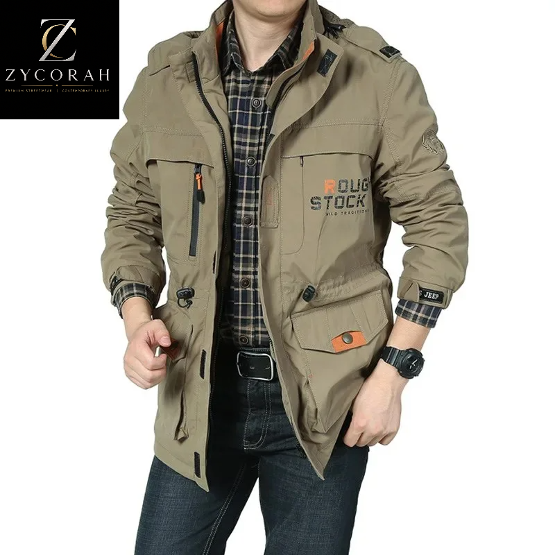 A man wearing a beige hooded jacket with multiple pockets, a plaid shirt, and jeans. The jacket features 'BOUG STOCK' printed on the chest pocket.