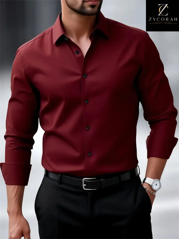 A man wearing a long-sleeve burgundy button-down dress shirt with black trousers and a black belt, shown from the chin down. The Zycorah brand logo is visible in the top right corner.