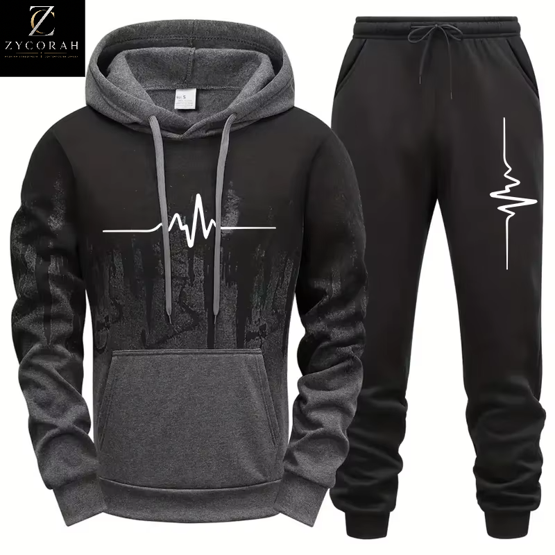 A two-piece athletic tracksuit set consisting of a black and gray pullover hoodie with a white heartbeat line graphic on the front, and matching black sweatpants with a white heartbeat line graphic on the left leg. The brand logo 'ZYCORAH' is visible in the top-left corner.