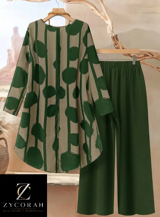 A women's two-piece outfit from ZYCORAH featuring a long-sleeve tunic top with a green and beige vertical stripe pattern and abstract green circles, paired with matching solid green wide-leg pants, displayed on wooden hangers.
