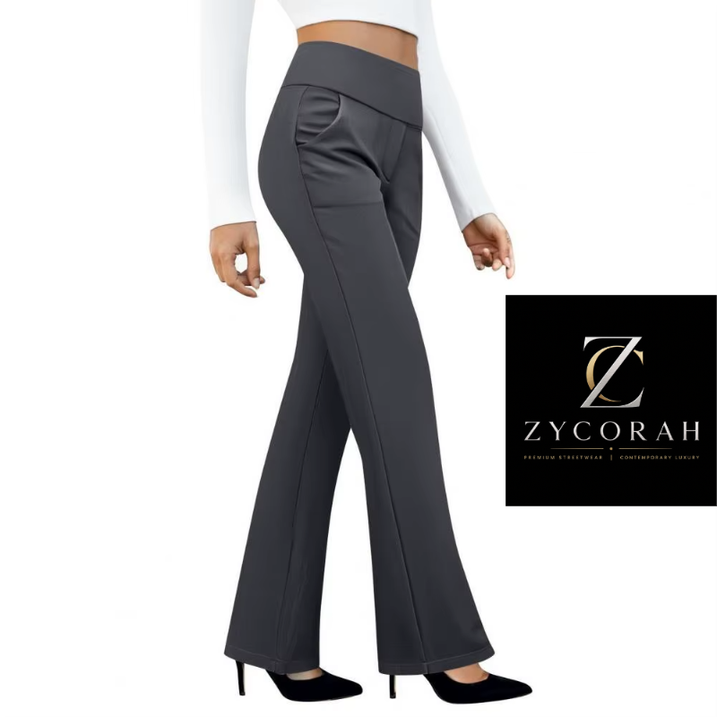 A model is shown from the waist down wearing dark gray wide-leg flare pants, a white long-sleeve crop top, and black heels. A black square logo for 'Zycorah' is visible in the bottom right corner against a solid white background.