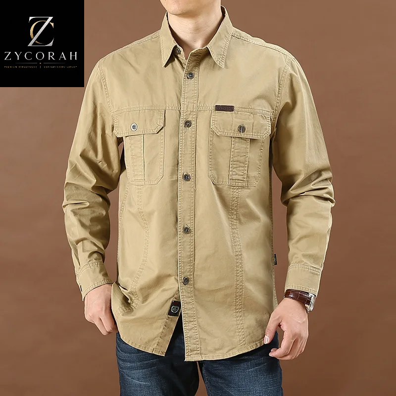 A man wearing a tan long-sleeve button-up shirt with two chest pockets, shown from the neck down against a brown studio background. A ZYCORAH logo appears in the top-left corner.