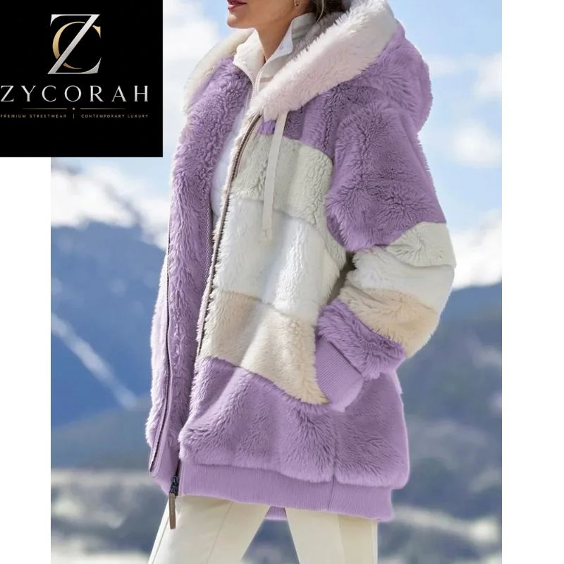 A woman wearing a plush patchwork sherpa jacket in lavender purple, cream, and white, set against a blurred mountain background. A black brand logo for 'Zycorah' is visible in the top-left corner.
