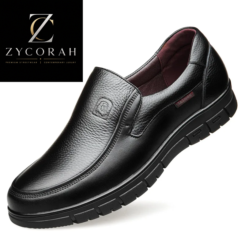 A black pebbled leather slip-on work shoe shown at a three-quarter angle on a white background, with a ZYCORAH brand logo card in the top-left corner.