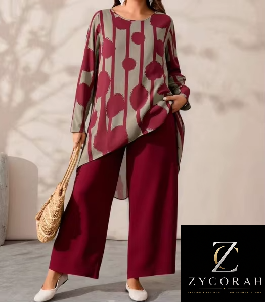 A woman models a two-piece outfit from ZYCORAH, featuring a long-sleeve top with a vertical striped pattern in olive green and deep magenta, paired with matching wide-leg trousers in deep magenta. She is holding a woven straw bag and wearing white pointed-toe flats, set against a neutral indoor background with soft shadows.