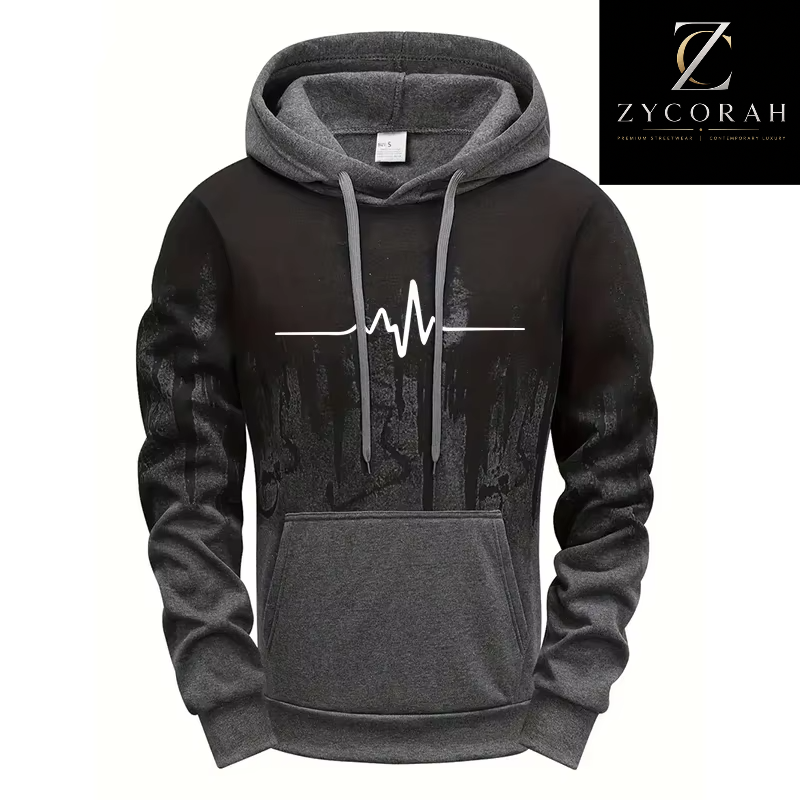 A men's pullover hoodie in black and dark gray, featuring a white EKG heartbeat line graphic across the chest. The hoodie has a solid dark gray kangaroo pocket and hood lining, ribbed cuffs and hem, and is displayed on a white background with a Zycorah brand logo in the top right corner.