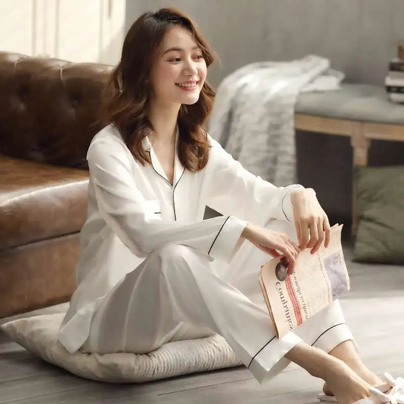 Women's  and men's satin pajama set featuring a button-up long sleeve top and matching pants in red, navy, black, white, purple, and champagne.