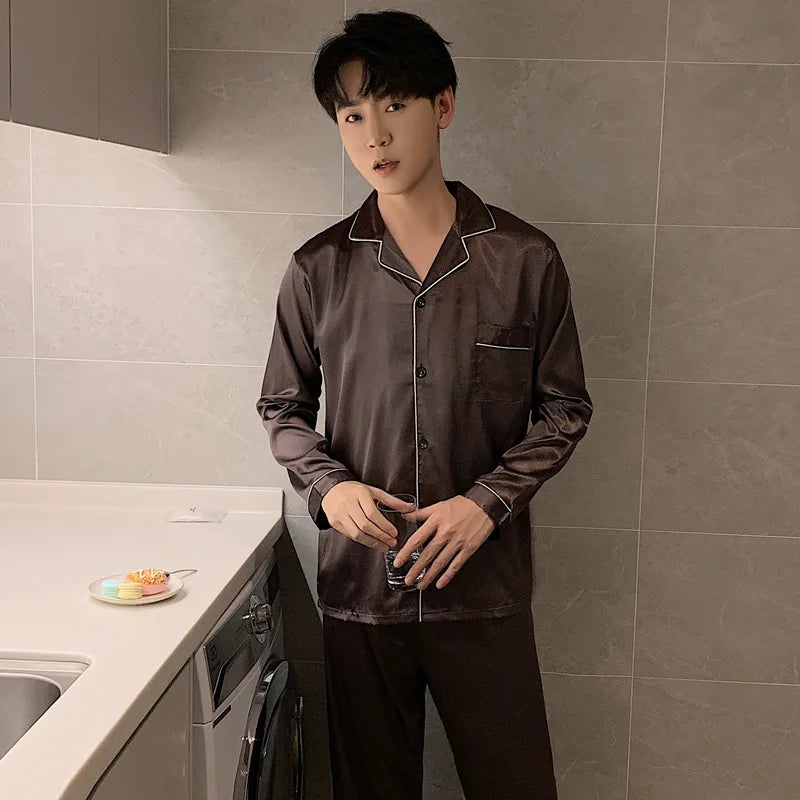 Person wearing brown satin pajamas standing in a kitchen.