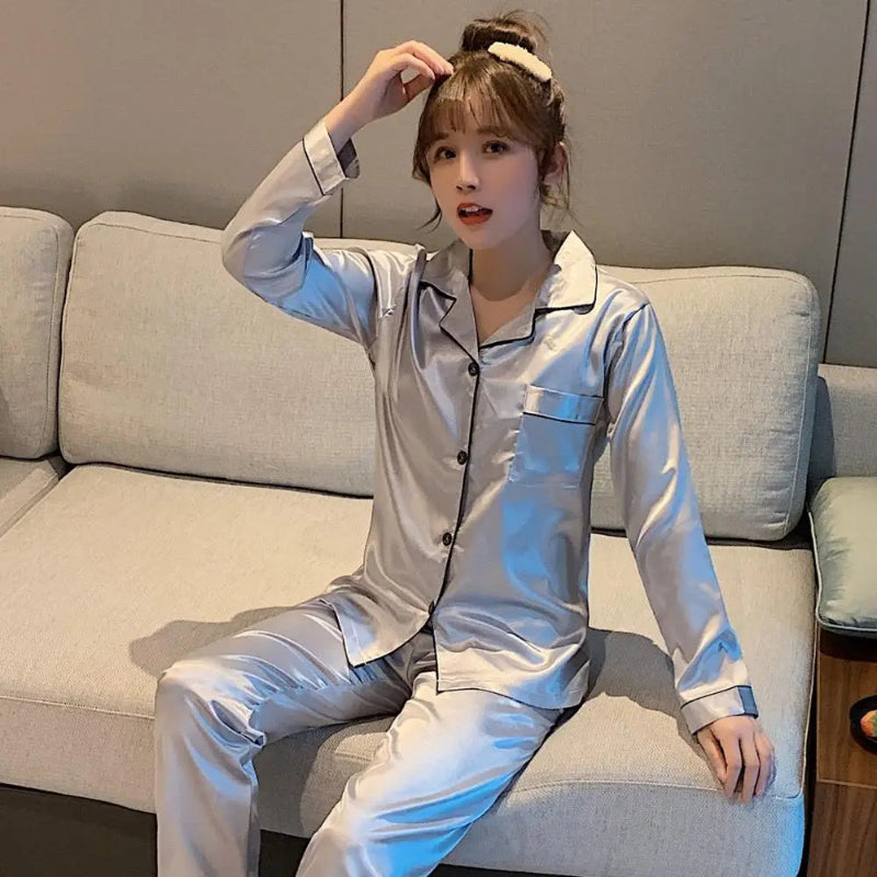 Women's  and men's satin pajama set featuring a button-up long sleeve top and matching pants in red, navy, black, white, purple, and champagne.