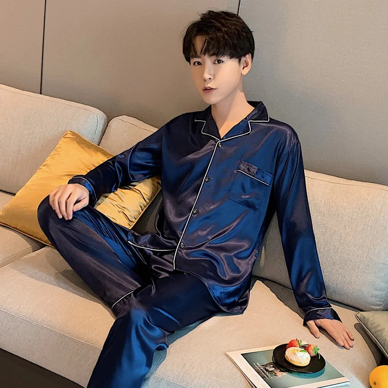 Person wearing blue satin pajamas sitting on a couch.
