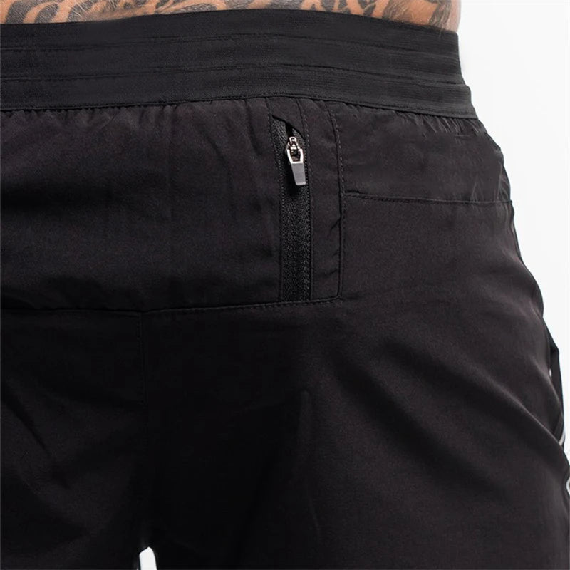 Close-up of black shorts with a zipper pocket on a white background