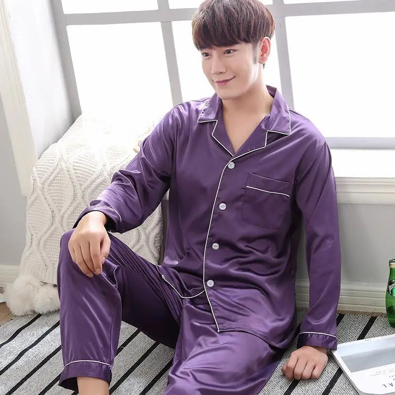 Person wearing purple pajamas sitting on a bed.