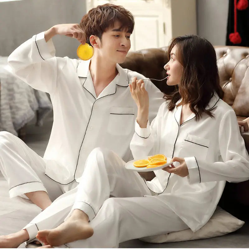Women's  and men's satin pajama set featuring a button-up long sleeve top and matching pants in red, navy, black, white, purple, and champagne.