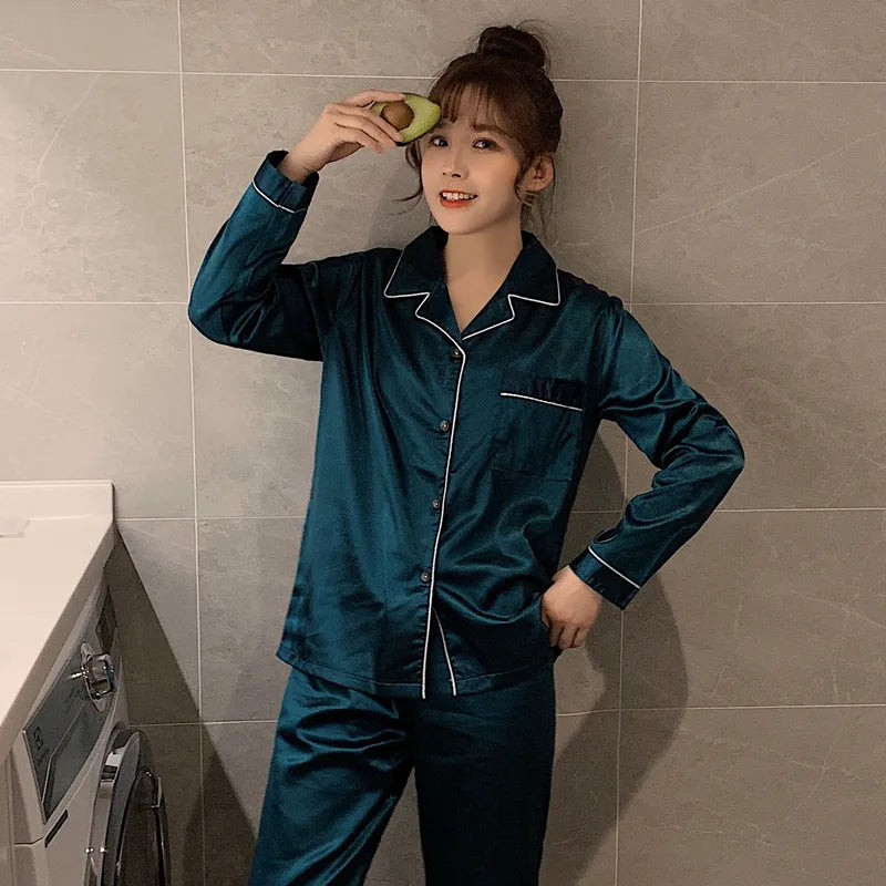 Woman wearing teal satin pajamas holding a avocado in a bathroom.