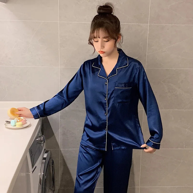 Woman wearing a blue satin pajama set in a kitchen.