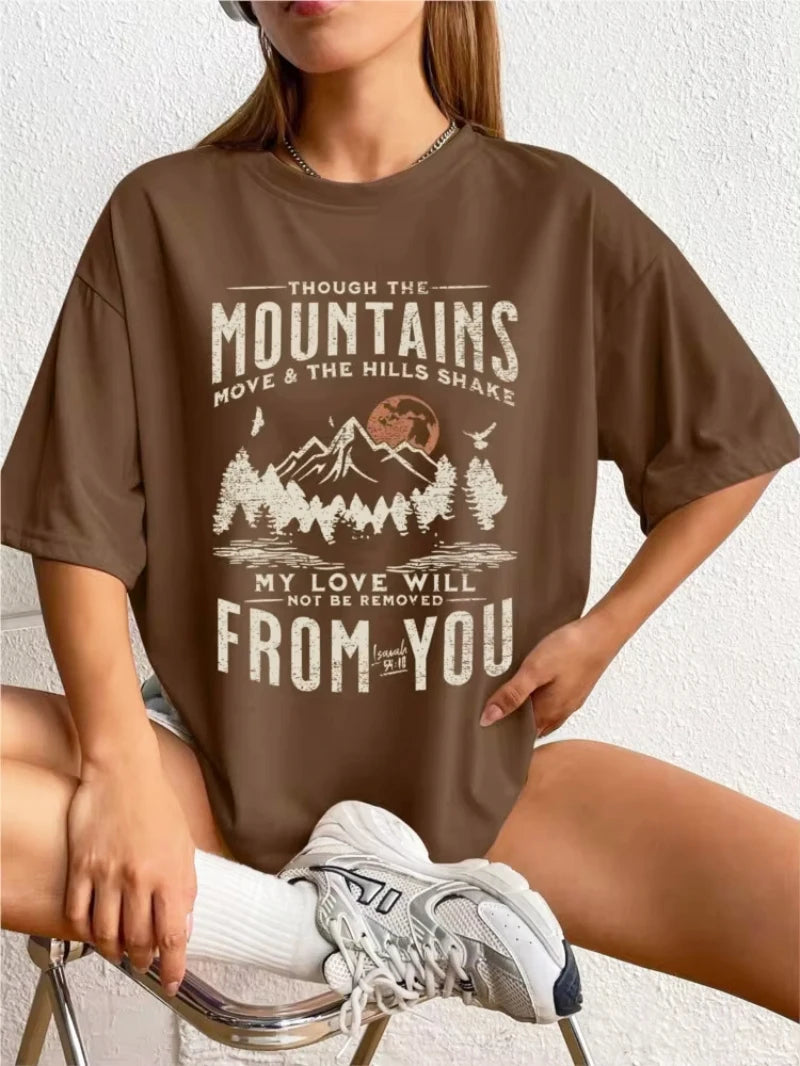 Person wearing a brown t-shirt with a mountain graphic and text.