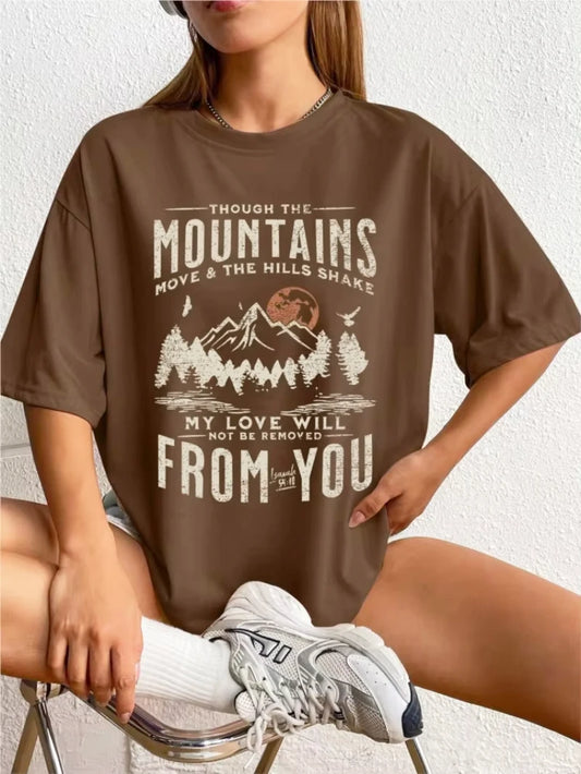 Person wearing a brown t-shirt with a mountain graphic and text.