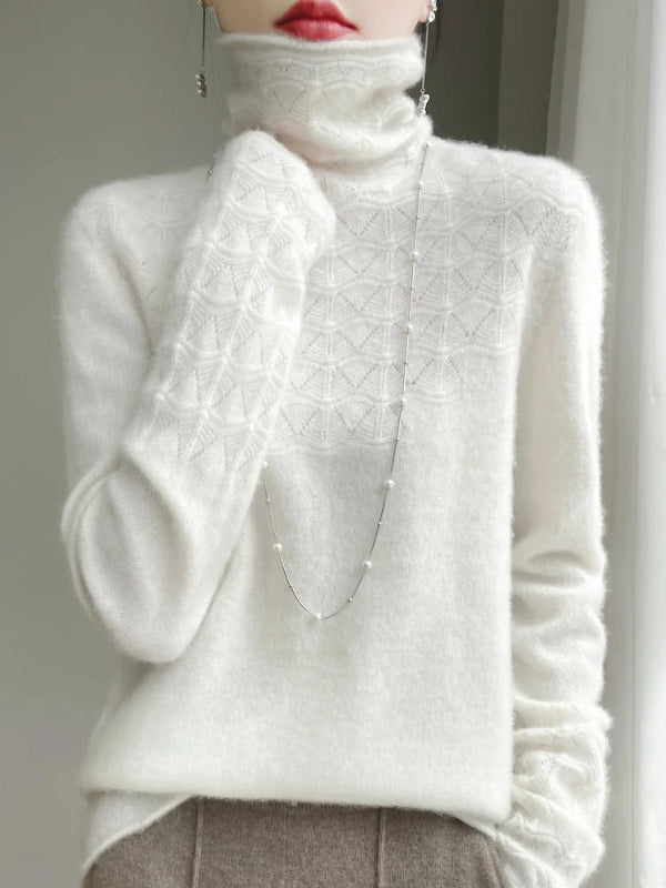 White turtleneck sweater with textured pattern worn by a person.