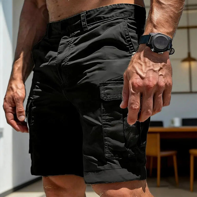 Person wearing black shorts with a blurred indoor background