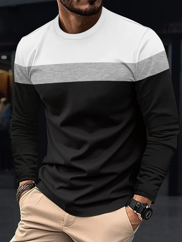 Man wearing a black and white long-sleeve shirt with a blurred background