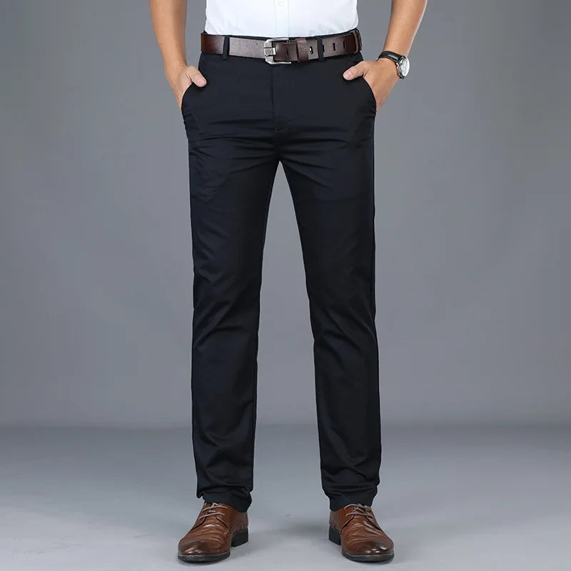 Person wearing black dress pants with a gray background