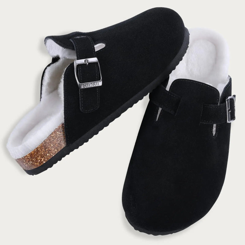 Black clogs with white interior and glittery sole on a light gray background