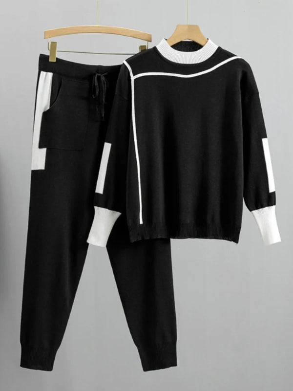 Black and white outfit on hangers against a gray background