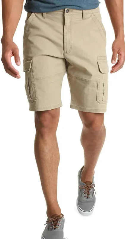Person wearing beige cargo shorts on a white background
