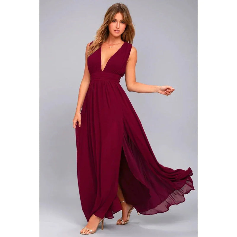 Woman wearing a burgundy evening gown on a gray background