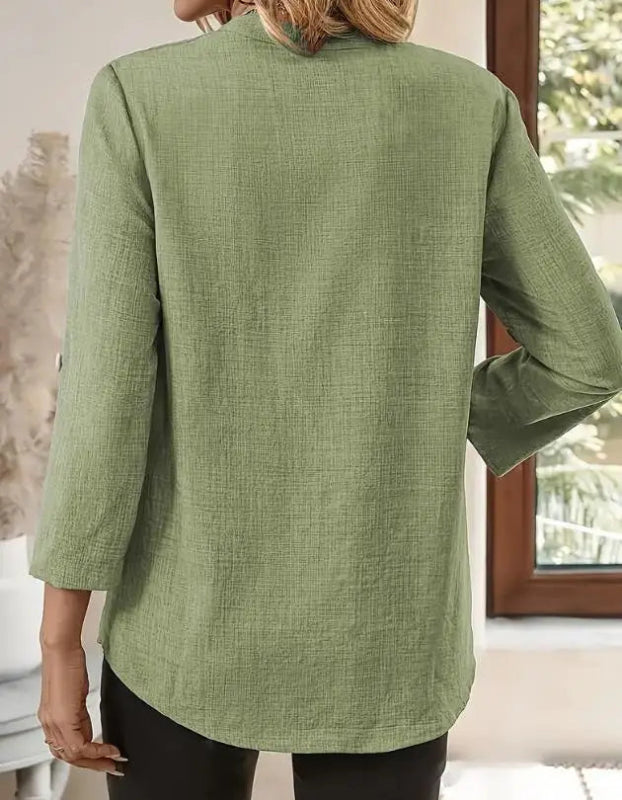 Green jacket worn by a person, with a neutral background