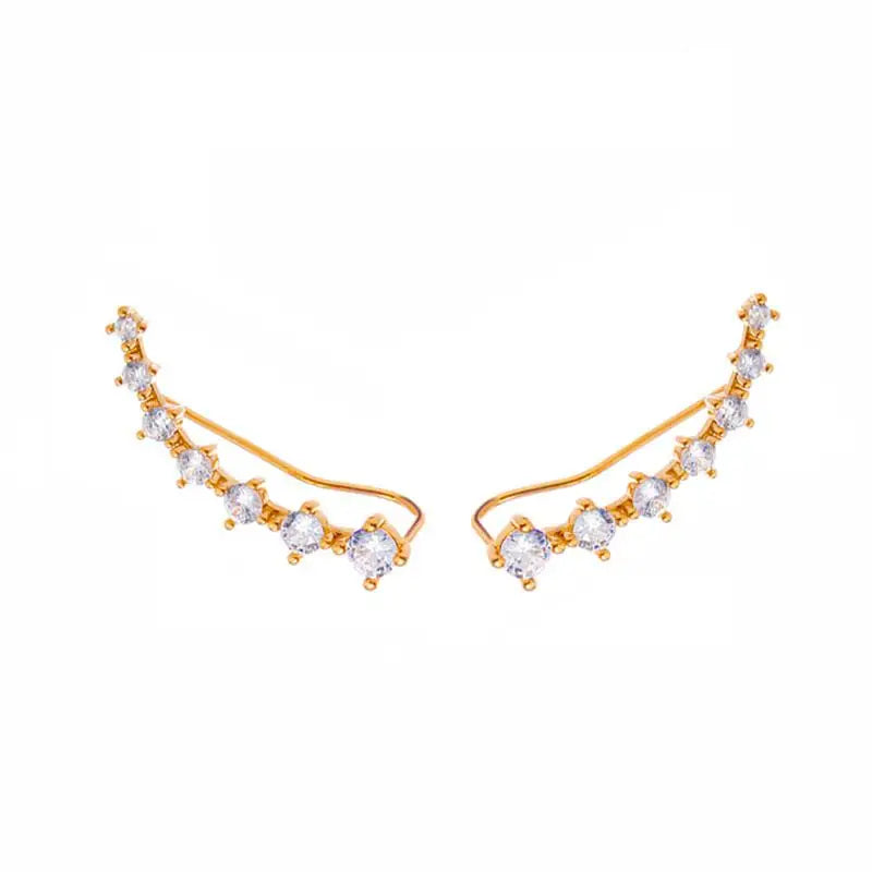 Gold and crystal ear cuffs on a white background