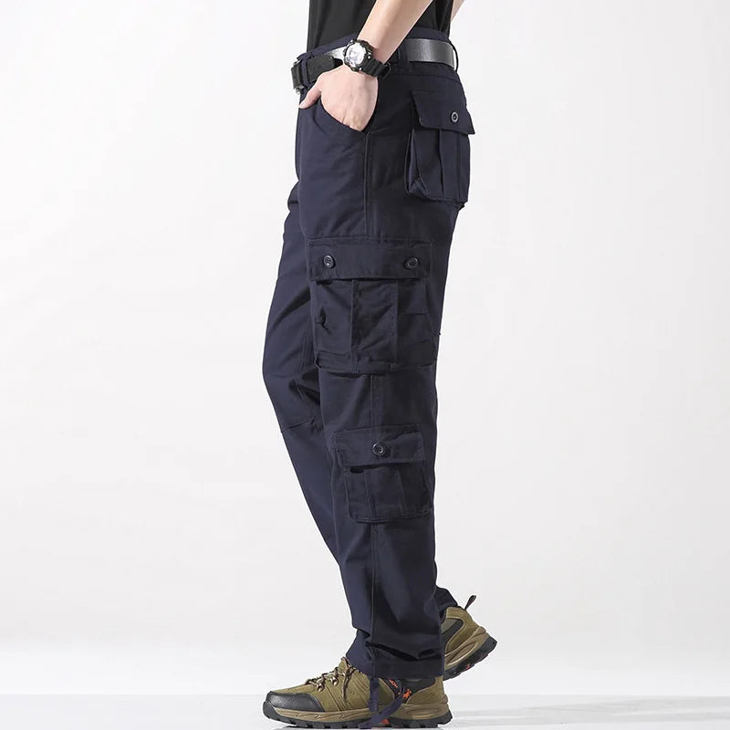 Navy cargo pants worn by a person on a white background