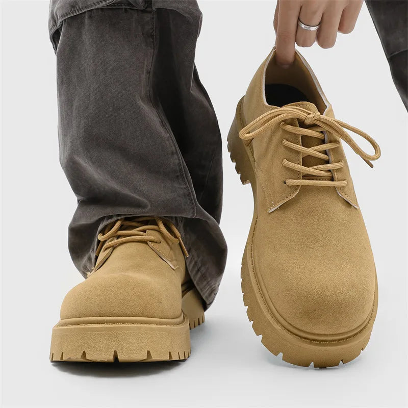 Tan leather shoes with a person wearing them on a light gray background