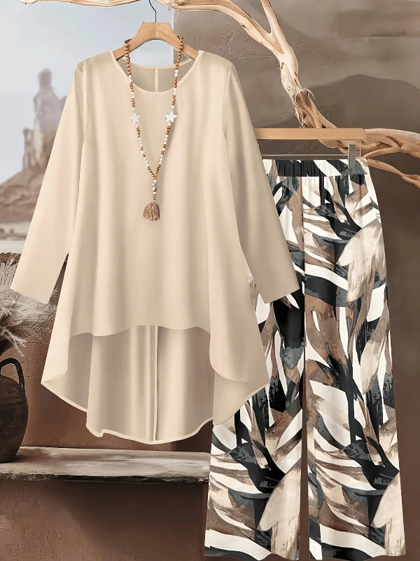 Beige top and patterned pants on a hanger with a neutral background