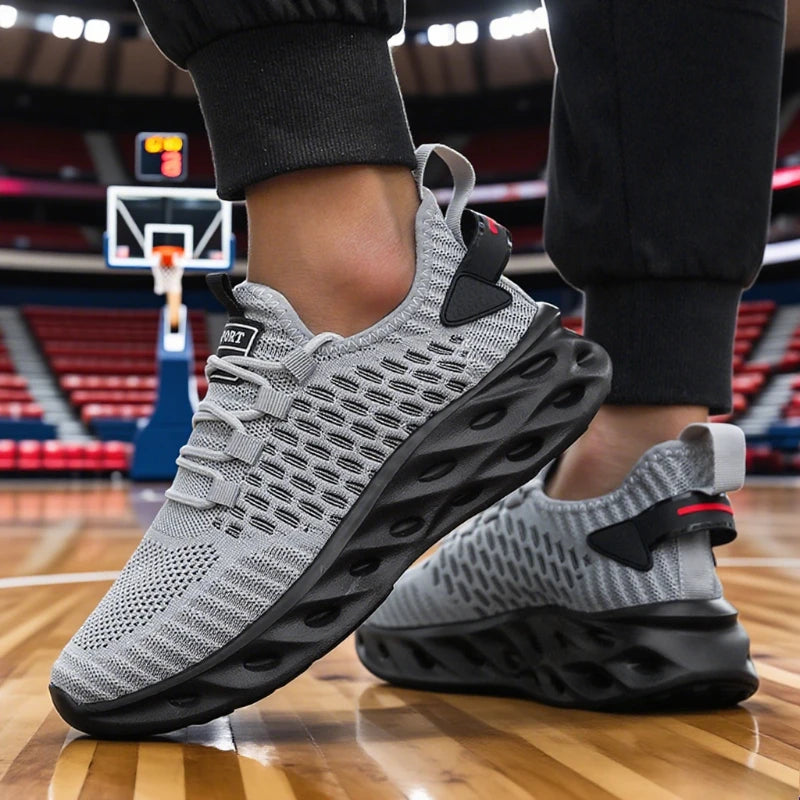 Gray athletic shoes with black soles on a basketball court