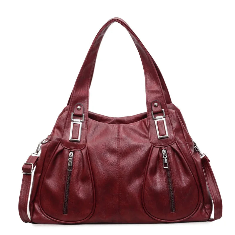 Maroon handbag with silver buckles on a white background
