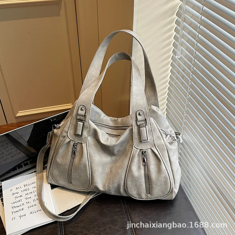 Silver handbag on a desk with a window in the background