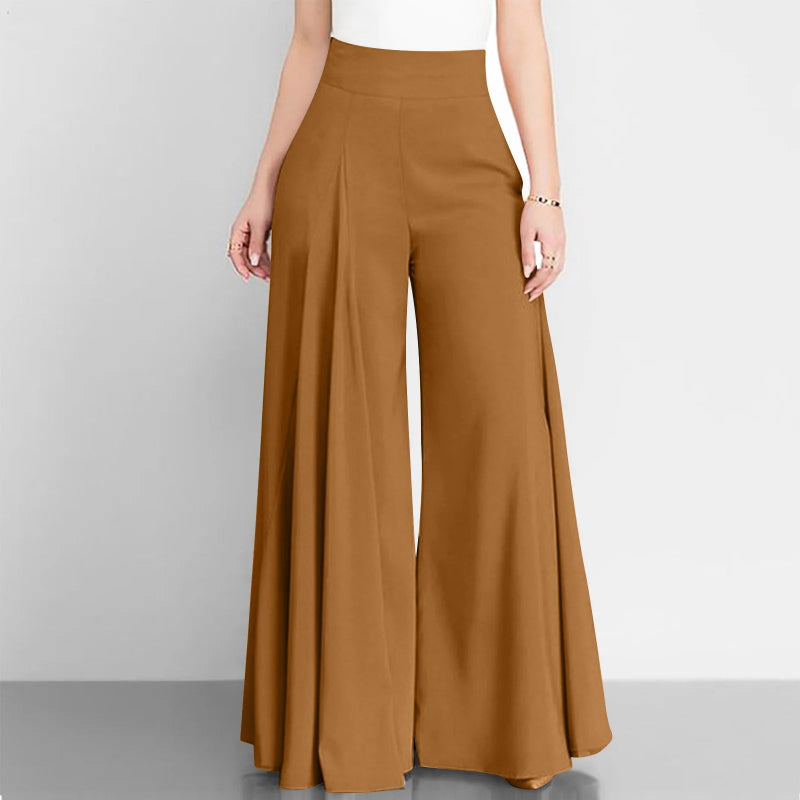 Brown wide-leg pants worn by a person on a gray background
