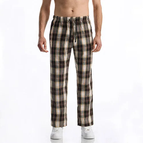 Man wearing plaid pajama pants on a white background