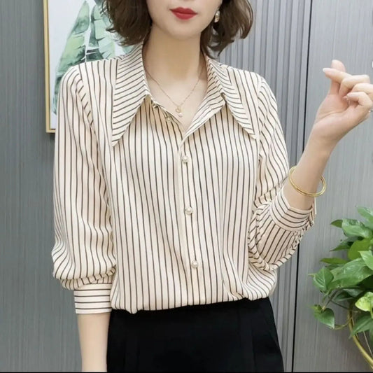 Woman wearing a striped blouse with a neutral background
