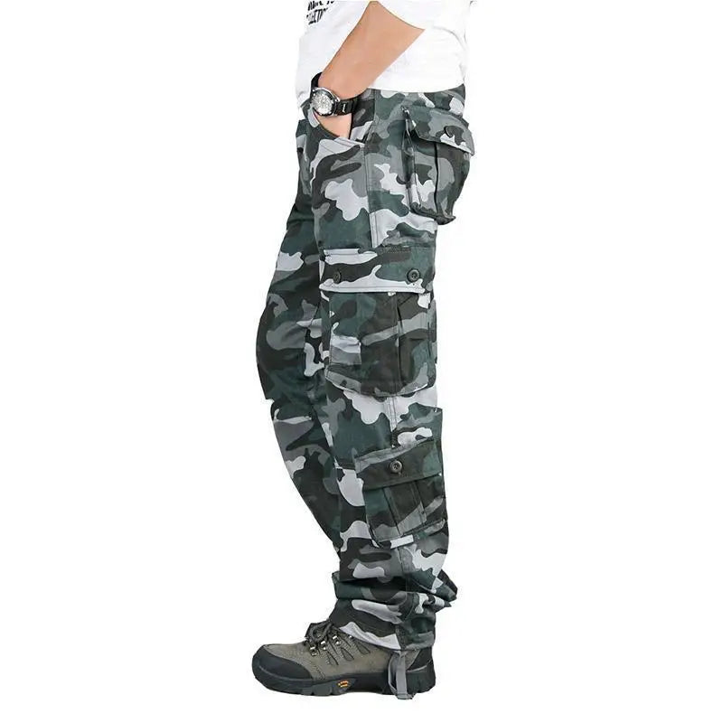 Camouflage pants worn by a person on a white background