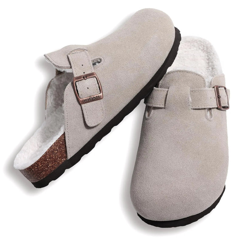 Pair of gray suede clogs with buckle straps on a white background