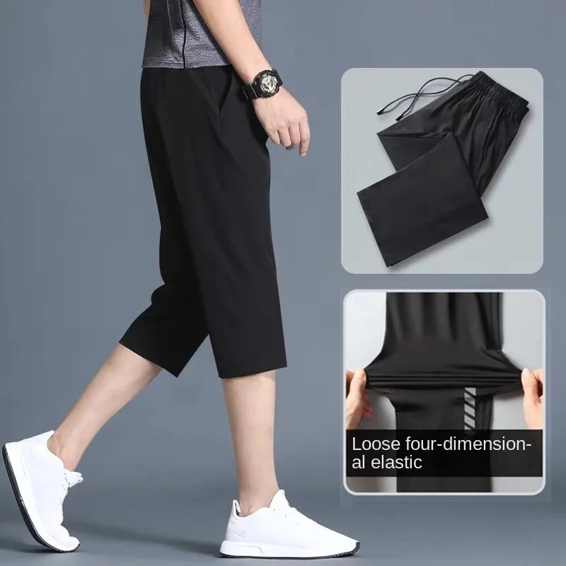 Person wearing black loose-fitting pants with a gray background and inset images showing the pants' flexibility.